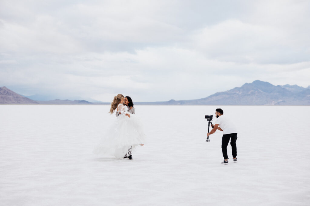 Photographer capturing couple on expansive salt flats.