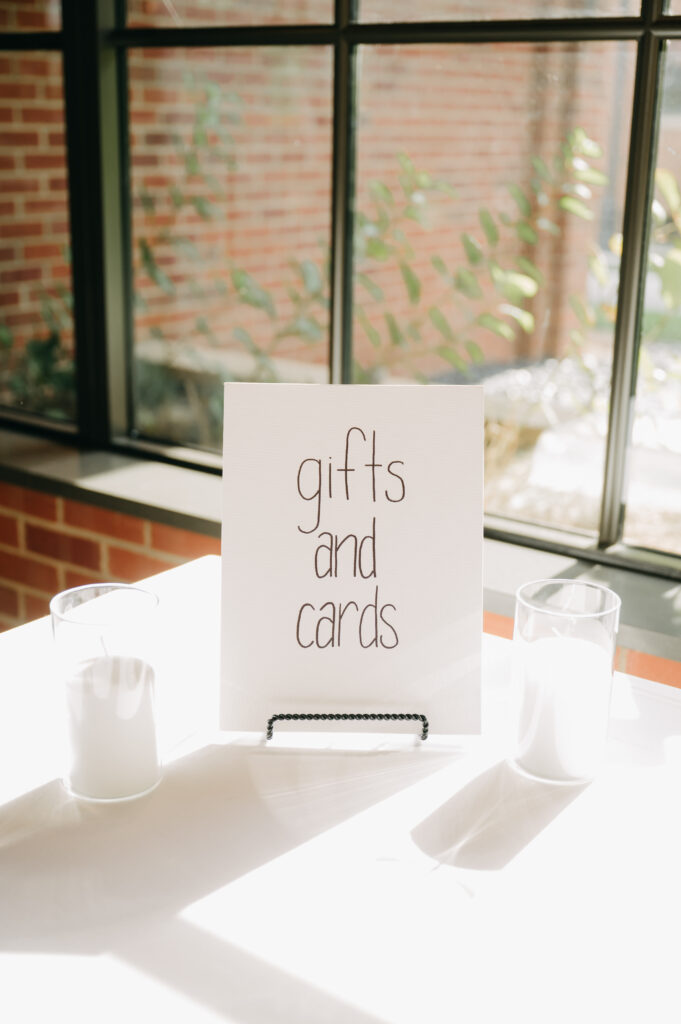 Gifts and cards sign on table