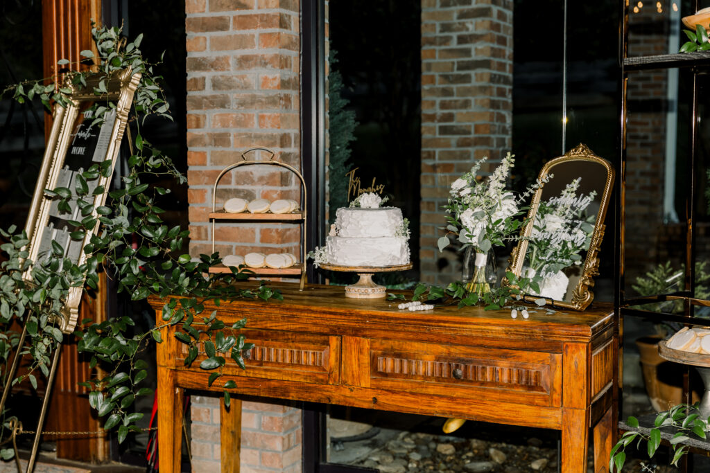 Wedding cake table with decorative greenery