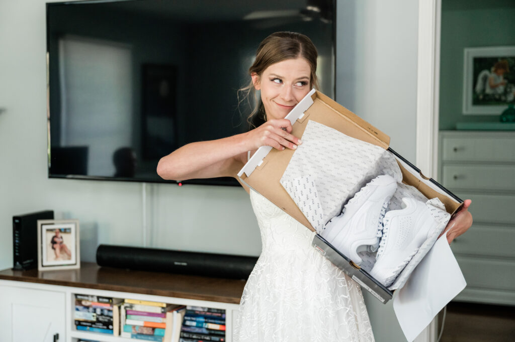 Woman smiling with white sneakers gift box.